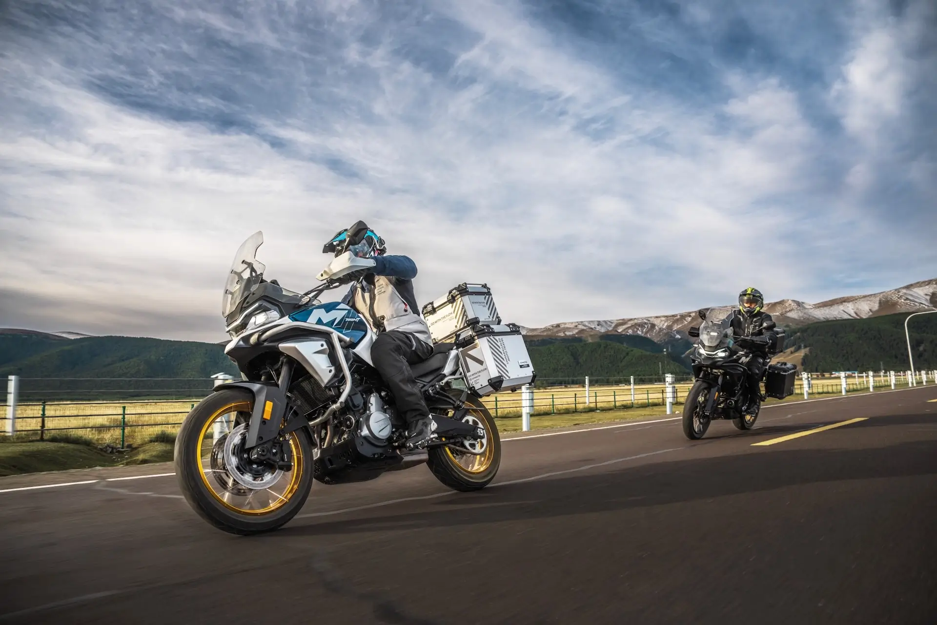 CFMOTO 700MT duo touring mountain road with dramatic sky