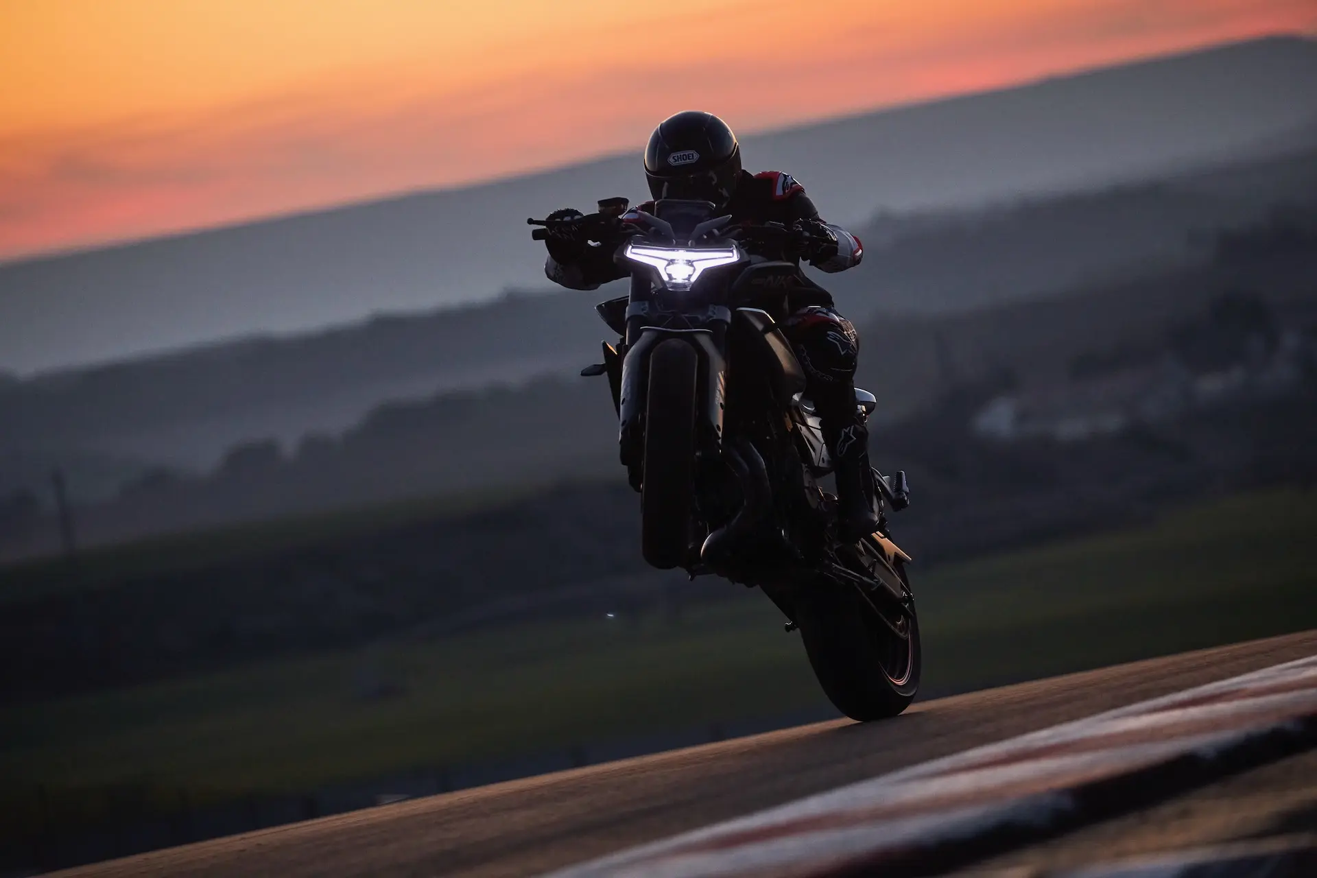 CFMOTO 800NK wheelie at sunset
