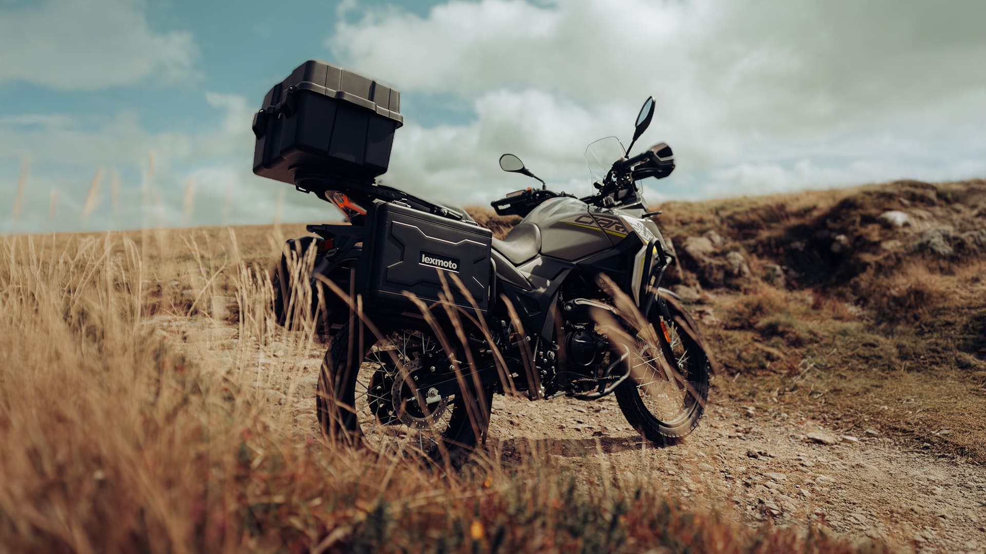 Lexmoto Carrera 125 on a moorland hillside with full luggage