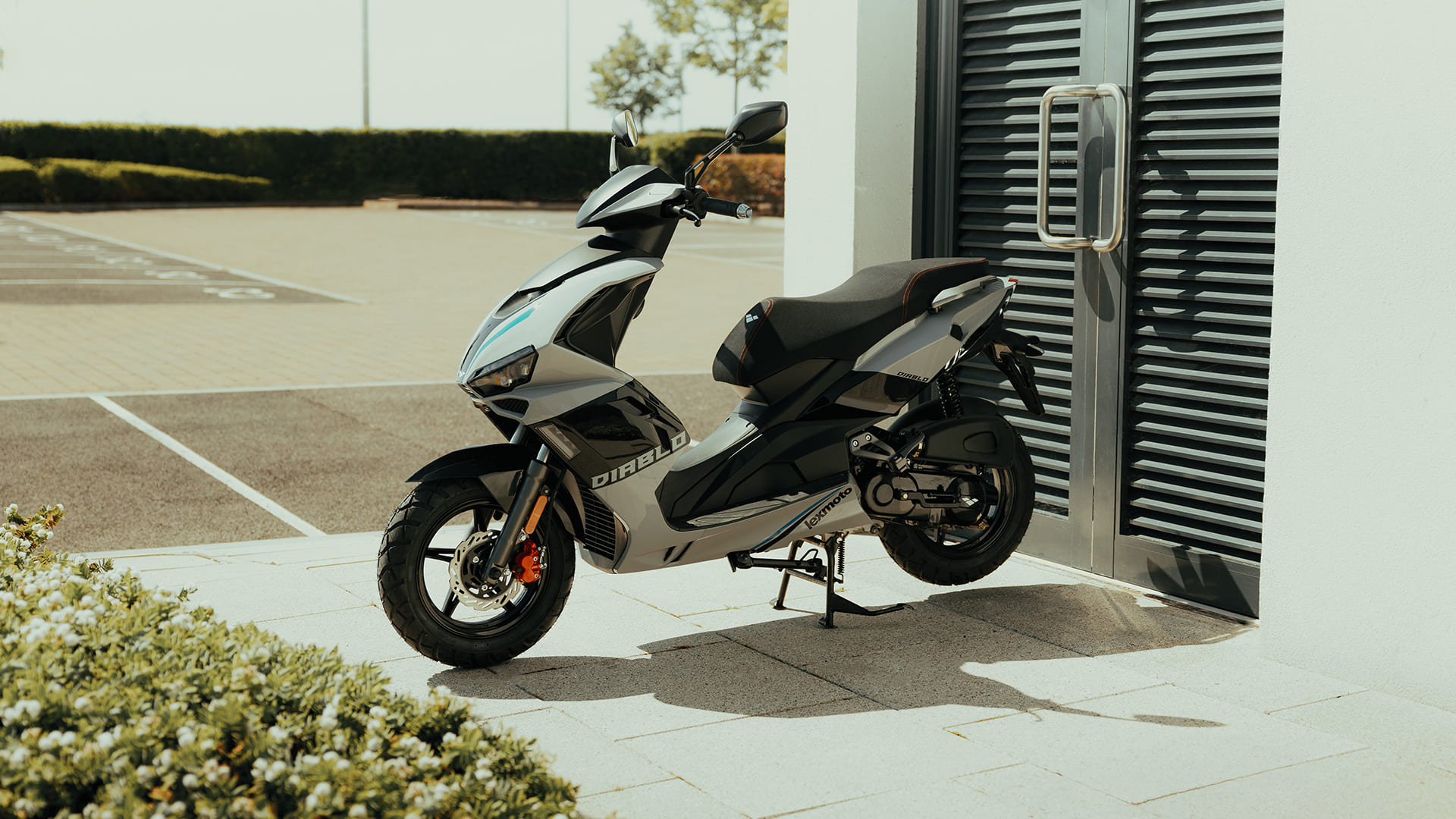 Diablo 50 front three-quarter parked next to modern building with shutters