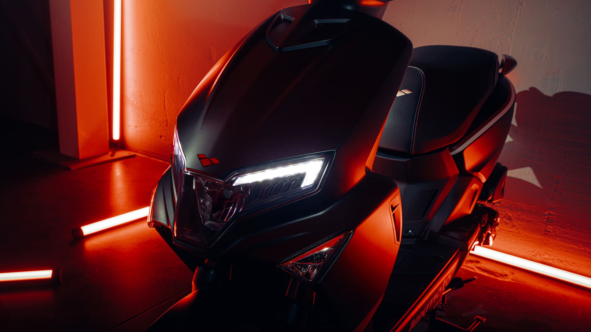 L5 aggressive LED headlight close-up with red neon ambient lighting