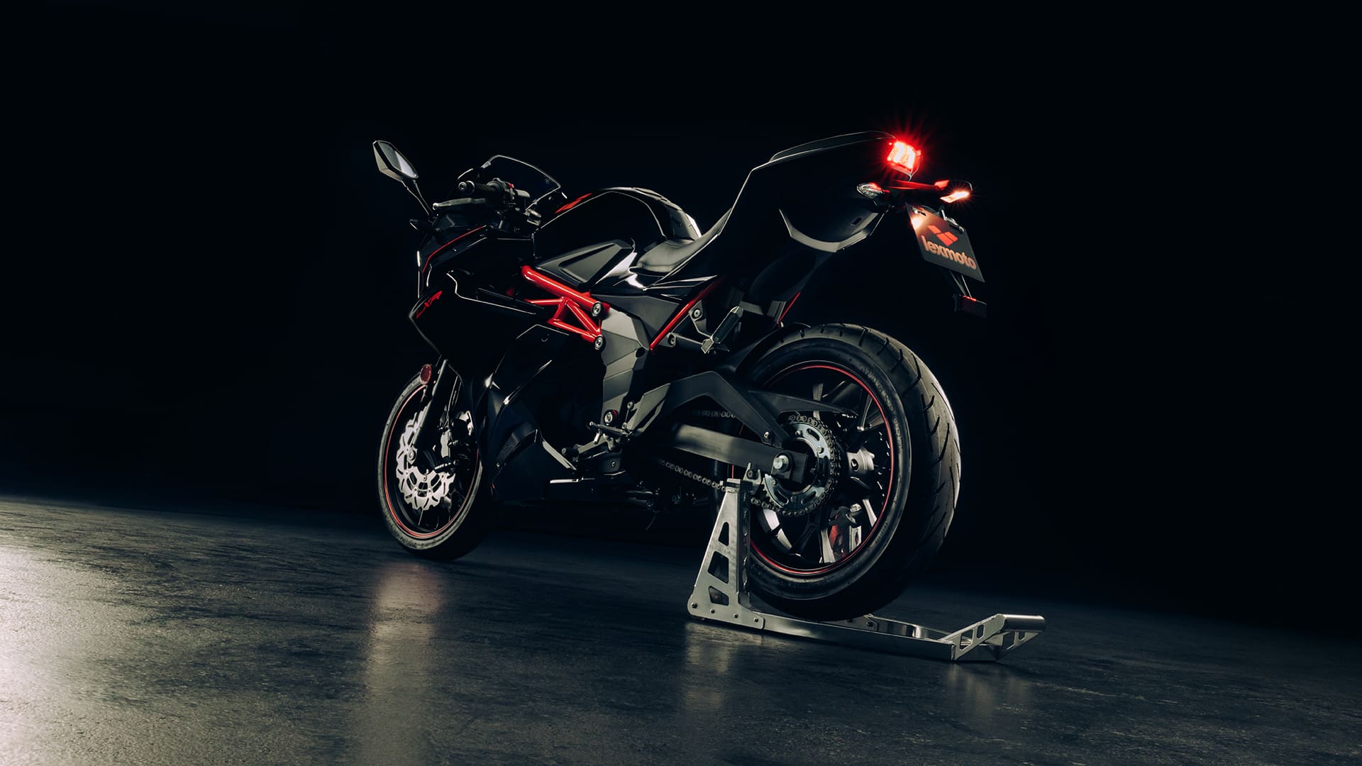 LXR 125 Black/Red rear view with tail light glowing
