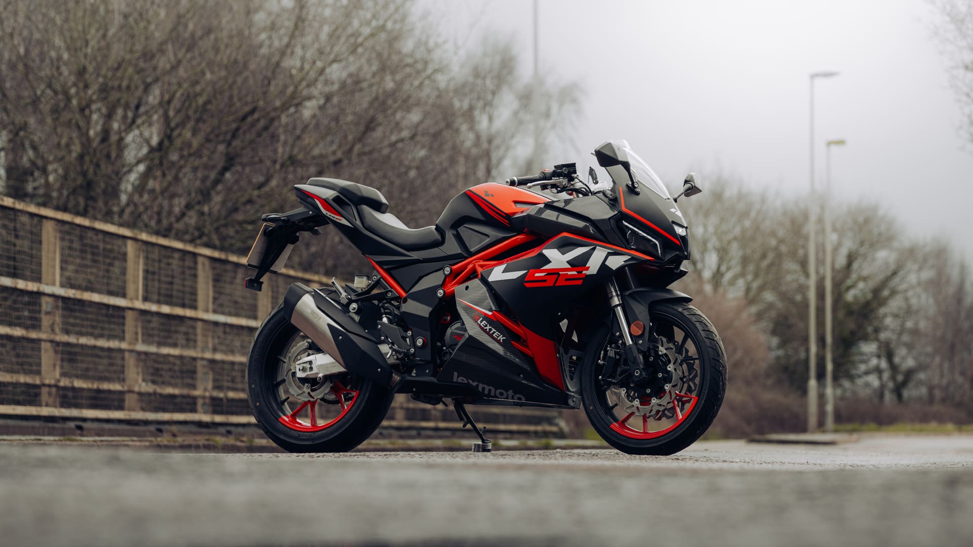 LXR SE 125 parked by fence, front three-quarter view