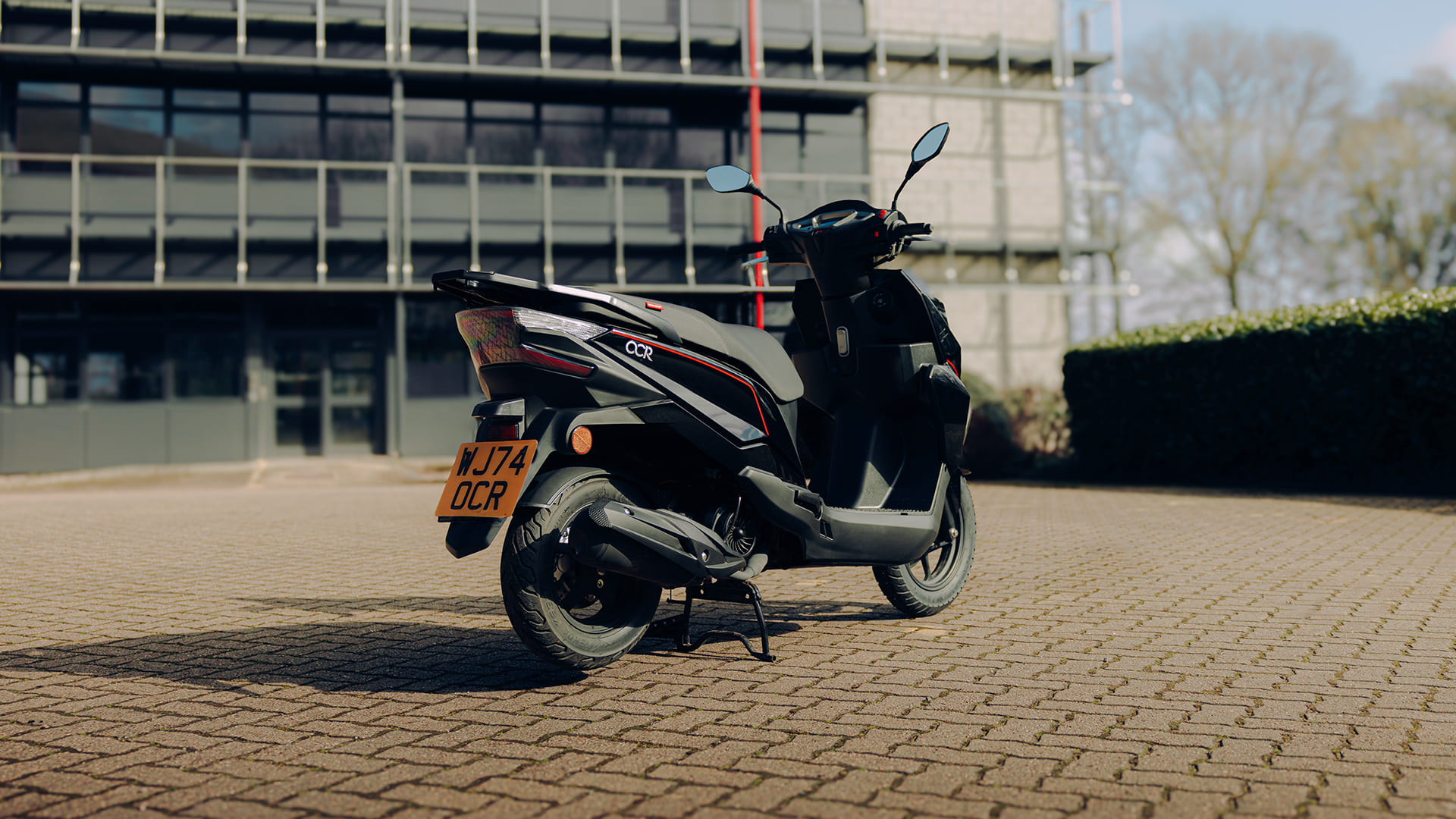OCR 125 rear three-quarter parked outside office with number plate