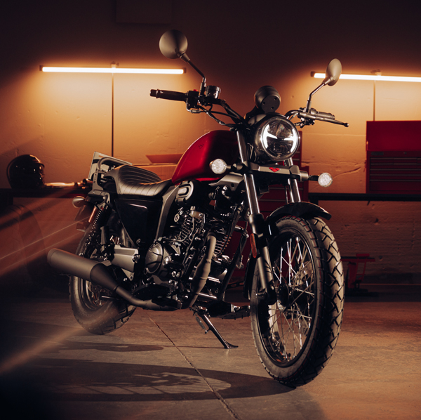 R66+ Red close-up front three-quarter showing headlight and spoke wheels