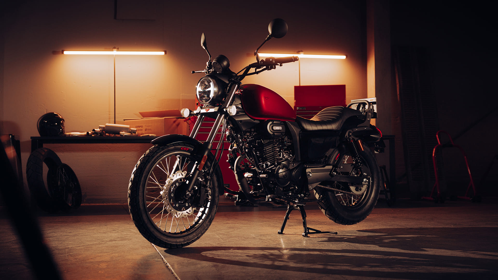 R66+ Red front three-quarter in moody garage with warm backlighting